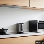 소형 전자레인지 추천 - A modern compact kitchen interior featuring a sleek, matte white microwave oven placed on a small co...